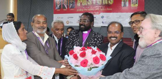NPF leaders welcoming guests with flowers at the conference